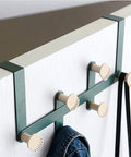 Slick Wall Mounted Coat Hooks And Door Hanging Multi Rack Heavy Duty Storage Easy Peasy Setup For Bedrooms Bathrooms Closets To Keep Life Dang Tidy And Super Neat features green metal frame with cream hooks holding a jacket.