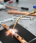 Welder using 9x12 Inch Heavy Duty Heat Shield Barrier Blanket With Reflective Insulation Carbon Felt For High Temp Protection.