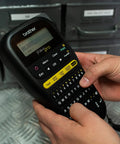 Knockout Performance P Touch Pro Label Maker equipped with one touch keys, handheld design, displaying text input for electrical labeling.