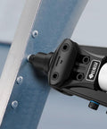 Beefy Heavy Duty 1/4 Inch Rivet Gun Kit attaching rivets to metal surface for DIY and home use.