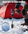 Using All In One Ice Anchor Tool Kit With 10 Pieces, cordless drill securing tent with ice screw anchors on snowy surface.