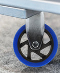 Close-up of Heavy Duty Five Inch Fixed Workbench Caster Wheels With Premium Black Rubber Tires mounted on metal for stable, quiet usage.