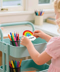 Child holding 120 Rainbow Name Plates For Classroom Desks Colorful Rainbow Students Name Tags Self Adhesive Locker Labels