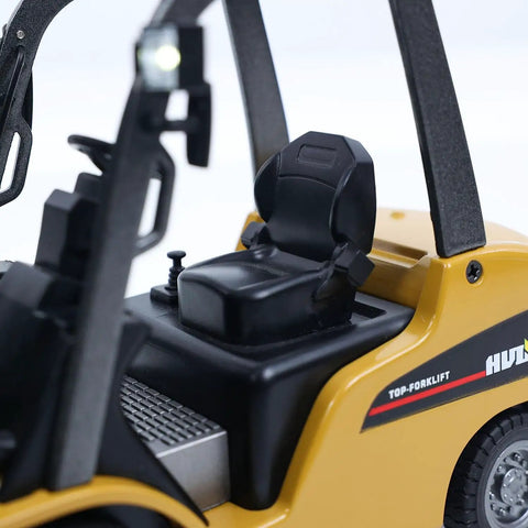 Mini Warehouse RC Forklift Model 9925 With Realistic Light And Sound Effects Precise Steering Lift Lower Function Plus Remote Control Operation For Indoor Play interior seat detail showing compact design and realistic controls.