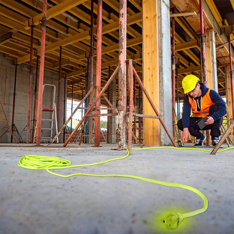 Worker using Heavy Duty Indoor Outdoor Extension Cord 50 Ft 14/3 AWG SJTW With Lighted Plug Go To Workhorse on construction site.