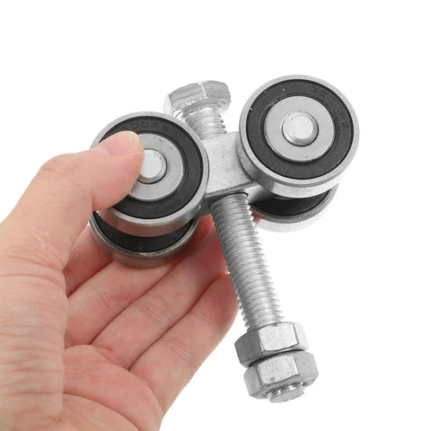 Heavy Duty Dual Bearing Sliding Door Pulley Roller In Tough Matte Black Steel, held in hand, showing dual wheels and mounting bolt.