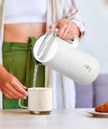 Person pouring from Real Deal Thermal Coffee Carafe Holds Fifty Ounces Advanced Vacuum Insulated Stainless Steel Beverage Dispenser.
