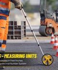 Zozen 6-Inch Measuring Wheel in Feet and Inches, Extended Telescopic Handle measuring distances on a construction site.