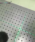 Green Cross Laser Alignment Light For Heat Press And Screen Printing, Focusable And Adjustable Line Width, shining on a perforated surface