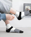 Black And White Checkerboard Straight Tube Socks Crafted From Buttery Soft Polyester For Elite Breathability And Quick Dry Comfort A Dead Set Classic For The Daily Grind Or Weekend Chill Sessions worn by a person with light jeans.