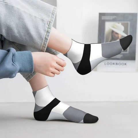 Black And White Checkerboard Straight Tube Socks Crafted From Buttery Soft Polyester For Elite Breathability And Quick Dry Comfort A Dead Set Classic For The Daily Grind Or Weekend Chill Sessions worn by a person with light jeans.