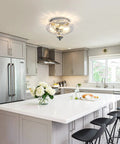 Modern Two Light Hammered Glass Flush Mount Ceiling Light In Chrome Finish, shown in a bright kitchen, 10.2 inch diameter.