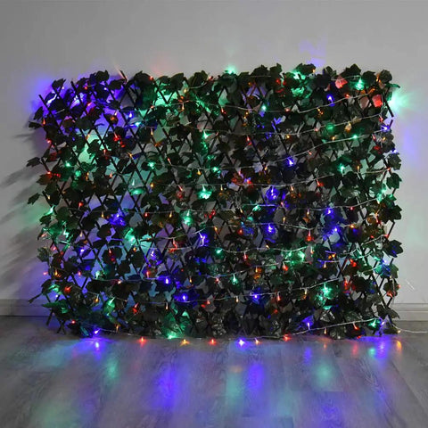 Expandable Faux Ivy Privacy Screen For Balcony And Patio Ideal Outdoor Fencing Panel With Realistic Artificial Hedges lit with colorful lights