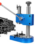Heavy Duty Cast Iron Desktop Arbor Press Kit with a red handle and metal bars for manual stamping and bending.