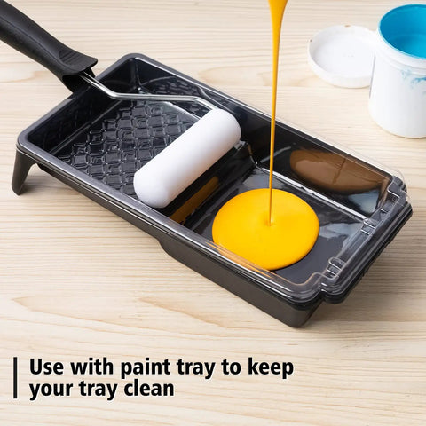 Disposable 4 Inch Paint Tray Liners Set With Plastic Tray And Roller Frame being used with liquid paint for DIY painting.