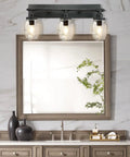 Industrial Mason Jar Vanity Light Wall Sconce In Black Finish with glass jar shades above a bathroom mirror