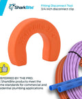 Three Quarter Inch Disconnect Clip For Push To Connect Brass Plumbing Fittings Quick Release Tool No Tools Needed For Easy Removal Fits Universal Push To Connect Brass Fittings U712A displayed next to coiled pipes.