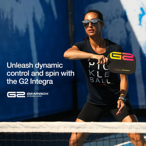 Player holding G2 Integra Edgeless Pickleball Paddle Black 8 Oz Lightweight Core 14mm Thickness in action on court