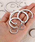 Hand holding various sizes of 12mm Internal Retaining Ring Circlip Kit 100 Pcs 304 Stainless Steel Internal Circlip Snap Rings C Clips GB893
