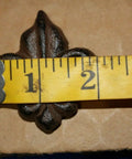 Measuring French Victorian Cabinet Knob in Cast Iron Fleur De Lis shape, 2 inches wide, for DIY projects.