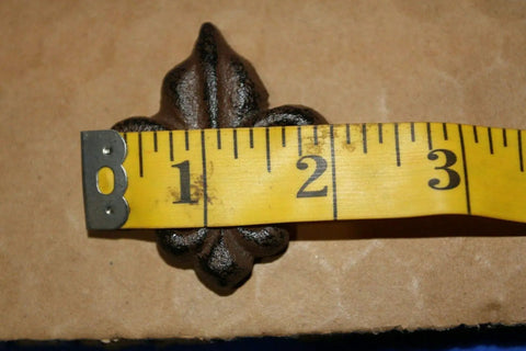 Measuring French Victorian Cabinet Knob in Cast Iron Fleur De Lis shape, 2 inches wide, for DIY projects.