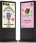 Hardcore 55 Inch Floor Standing Outdoor Digital Signage With Kickass 4500 Nits Brightness And Built Tough IP65 Waterproof Frame For No Sweat Wifi And Hdmi Video Displays In Retail Or Restaurants, showing vibrant candy advertisements.