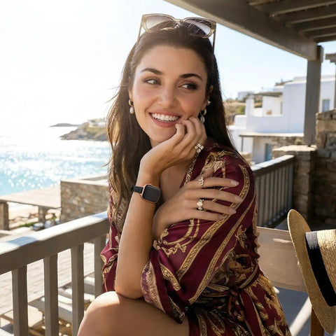 Pretty Sweet Slim Leather Band Compatible With Apple Watch For Women, worn by a smiling woman on a beachside patio.