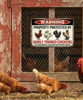 Warning Highly Trained Chickens Tin Sign For Chicken Coops And Farm Decor Funny Backyard Fence Sign Gag Gift For Chicken Lovers Weather Resistant Metal 8x12 Inch Outdoor Wall Plaque on coop door with chickens nearby.