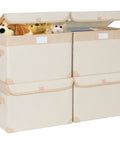 Four beige foldable storage bins with reinforced sides, holding toys and books, ideal for keeping your home organized. Kick Some Clutter To The Curb With These Roomy Foldable Storage Bins Featuring Tough Reinforced Side Panels And Snug Fitting Covers Designed To Keep Your Home Base Looking Sharp And Fully Organized All Year Round.