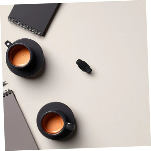 Top view of Heat Resistant Rubber Steam Wand Guard Sleeve for Coffee Machines with Burn Protection next to black cups