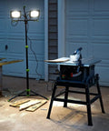 14,000 Lumen LED Work Light With All Metal 60 Inch Telescoping Tripod Stand illuminating a construction site at night
