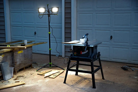 14,000 Lumen LED Work Light With All Metal 60 Inch Telescoping Tripod Stand illuminating a construction site at night