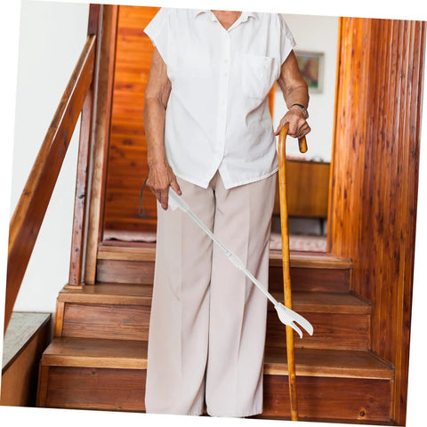 Long Reach Grabber Tool For Seniors 28 Inch Portable Reacher With Non Slip Grip And Stainless Steel Claw Ideal For Kitchen Balcony Home Care Travel The Ultimate Helper For Everyday Tasks At Home And On The Go. elderly woman using 28-inch white grabber on stairs