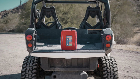Rapid Care First Aid Kit, red, in the truck bed of an off-road vehicle