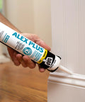 Person applying Paintable Siliconized Acrylic Caulk for Multi Surface Sealing and Waterproofing to baseboard joint