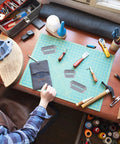 Person using Leather Die Punch Cutter Set in Steel with Hollow Punch Tools on crafting table, Cutting Mold Punching Kit visible