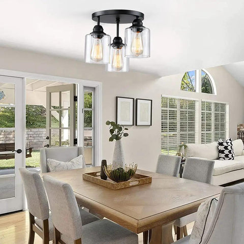 Three Light Industrial Semi Flush Mount Ceiling Fixture with Vintage Clear Seeded Glass Shade, Black Finish in dining room.