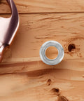 Stainless Steel Washing Machine Hub Nut Replacement Kit Durable Washer Nut Set on wooden surface with tool