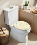 Elongated Vintage luxury seamless floral golden monstera leaves Toilet Seat on a white toilet in a modern bathroom setting.