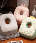 Cool Ice Silk Napping Face Pillow For Table Naps, ergonomic pillows in gray, pink, and green on a wooden table.