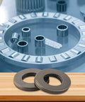 Thinking Process: AXK1528 thrust needle roller bearing with hardened steel washers and needle cage on wooden surface