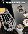 Person holding the Sprocket Fidget Bike Chain Hand Roller for Anxiety Relief and Sensory Fun, shown in black metal.