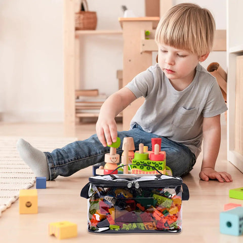 Child playing with toys next to See Through TPU Toy Organizer Bags With Zippers Extra Large Large And Medium Pouch Set Waterproof.