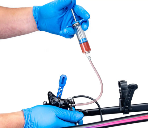 BKM12 Hydraulic Brake Bleed Kit For Mineral Oil with syringe and hose in use on a hydraulic braking system