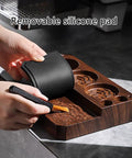 Hand using a brush on coffee grounds with The Legit Non Slip Portafilter Rack And Coffee Distributor Holder Tamper Stand Tool Organizer Tamping Station for Home Barista.