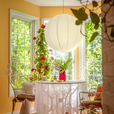Jumbo White Paper Lantern 30 Inch Indoor Decor For Large Rooms Elegant Reusable Accordion Style Lighting Ideal For Parties And Events Ceiling Decor Showstopper Vibe Party Ready hanging above a table in a sunny room.