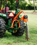 Rear Mounted 30 HP 3 Point Post Hole Digger With 9 Inch Auger for Cat 1 Tractors attached to a green tractor on grass
