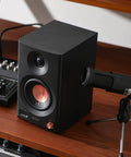 MR3 Powered Studio Monitors With Hi-Res Audio Certification And Bluetooth 5.4, black speaker shown on wooden desk