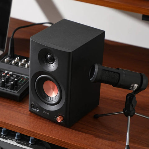 MR3 Powered Studio Monitors With Hi-Res Audio Certification And Bluetooth 5.4, black speaker shown on wooden desk