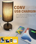 Set Of 2 Bedside Lamps With USB Port, 3 Way Dimmable Touch Control, Black Round Fabric Shade shown beside charging devices.